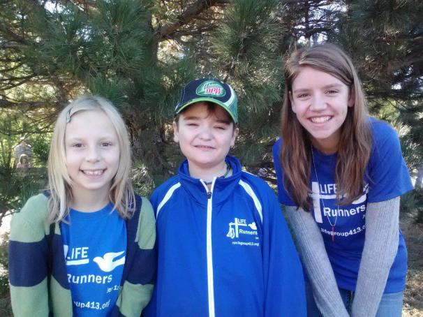 JP is pictured in the center between his two friends, Grace and Brianna.  